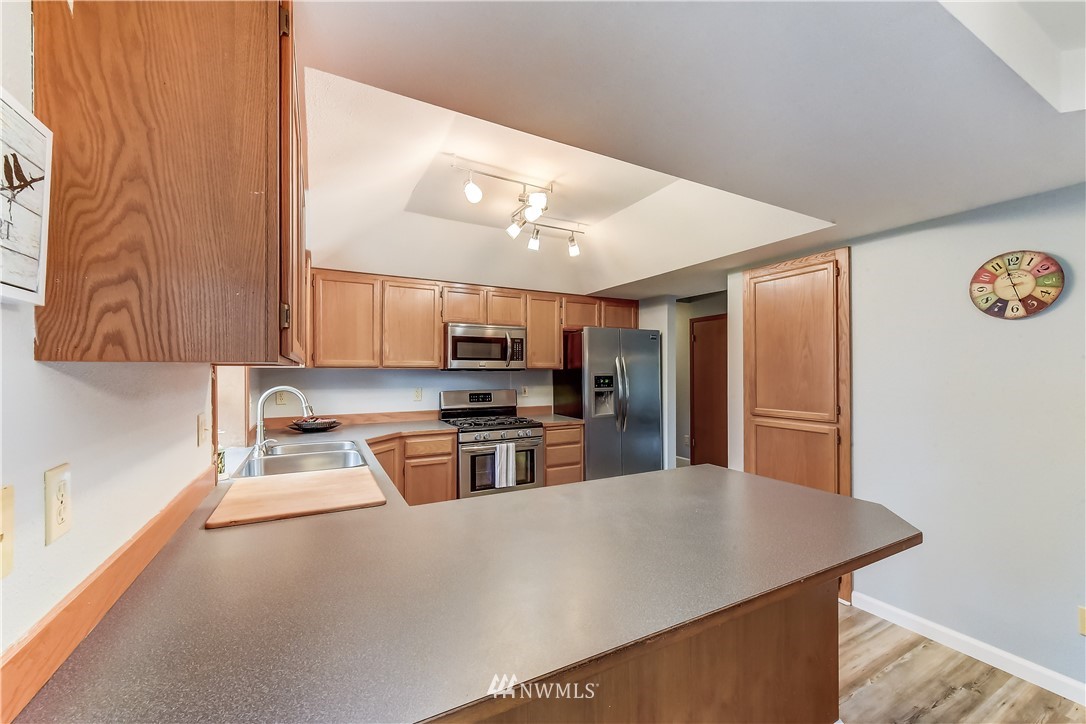 2319 Cherry Road Lake Stevens, WA 98258 - Photo 11 of 25 a kitchen with stainless steel appliances a refrigerator and a stove top oven