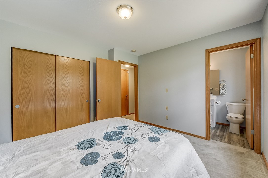 2319 Cherry Road Lake Stevens, WA 98258 - Photo 21 of 25 a bedroom with a large bed and a chandelier