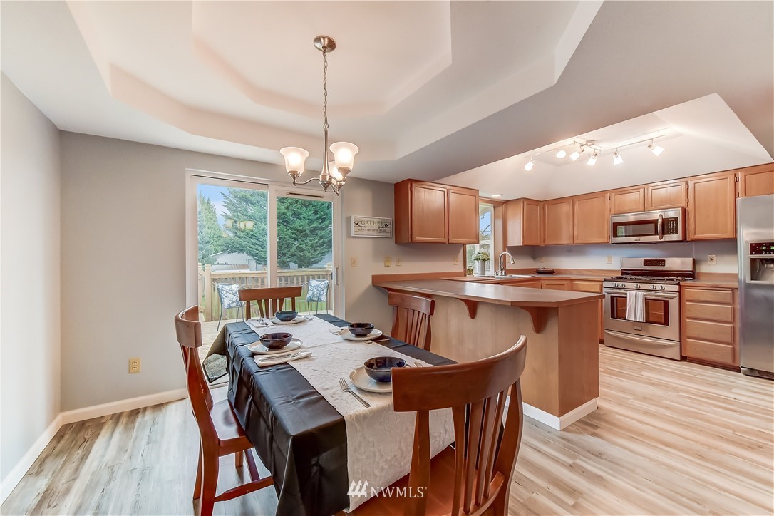 2319 Cherry Road Lake Stevens, WA 98258 - Photo 6 of 25 a view of a dining room with furniture window and wooden floor