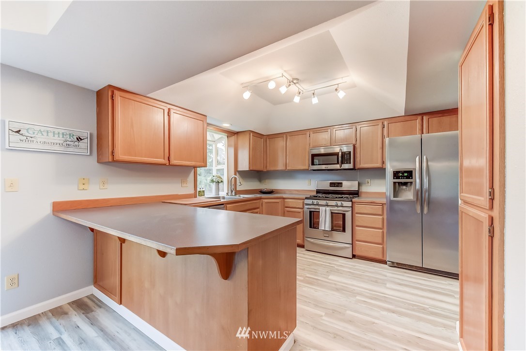 2319 Cherry Road Lake Stevens, WA 98258 - Photo 10 of 25 a kitchen with wooden cabinets a sink and stainless steel appliances