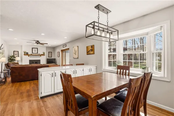 a view of a dining room with furniture window and wooden floor