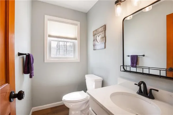a bathroom with a sink toilet and a mirror