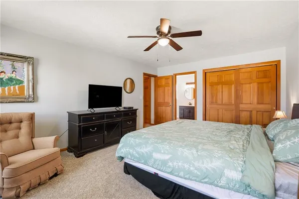 a bedroom with a bed and a television