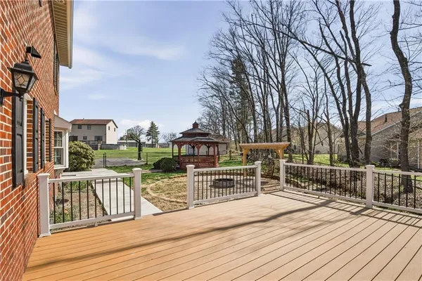 a view of a deck with wooden floor and fence
