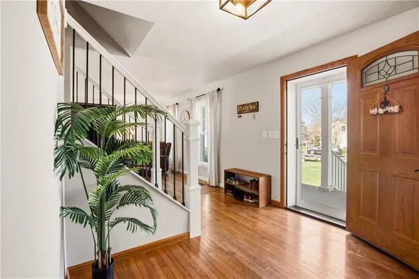 a porch with furniture and a potted plant
