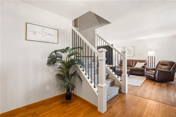 a view of entryway and hall with wooden floor