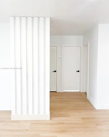 a view of a room with wooden floor