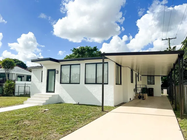 a house view with a swimming pool fire pit tables and chairs