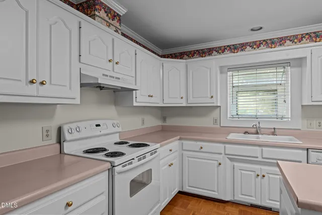 a kitchen with a sink stove and cabinets