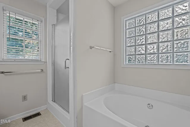 a bathroom with a granite countertop sink and a bathtub