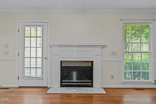 a living room with a fireplace and a floor to ceiling window