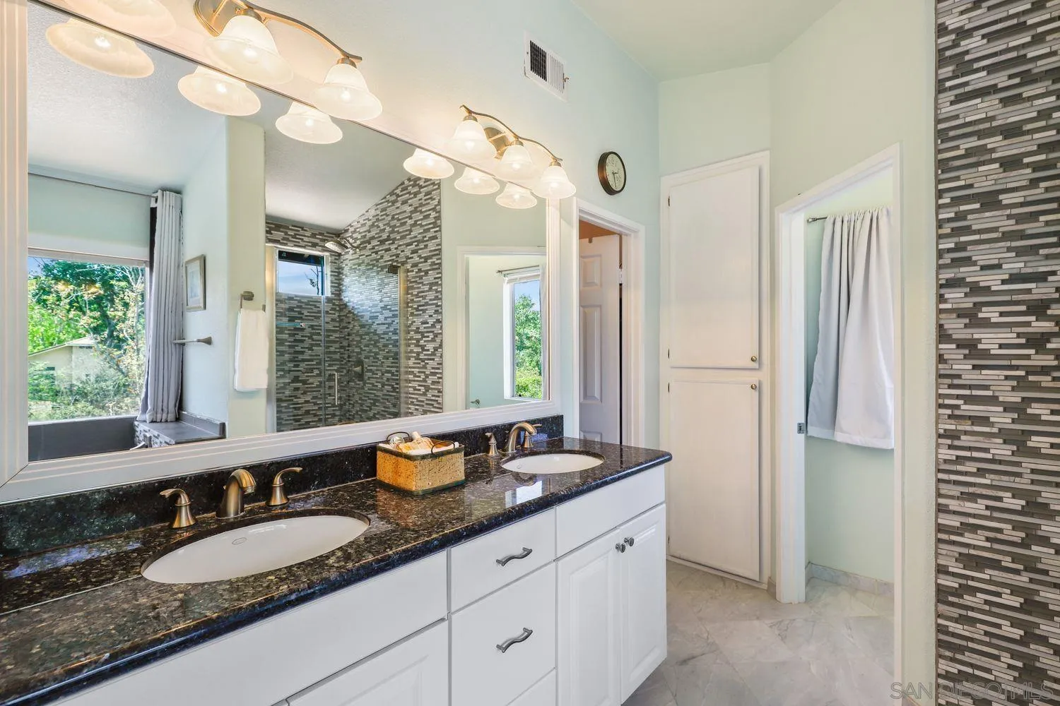 1769 Willowhaven Road Encinitas, CA 92024 - Photo 17 of 36 a bathroom with a granite countertop sink and a mirror