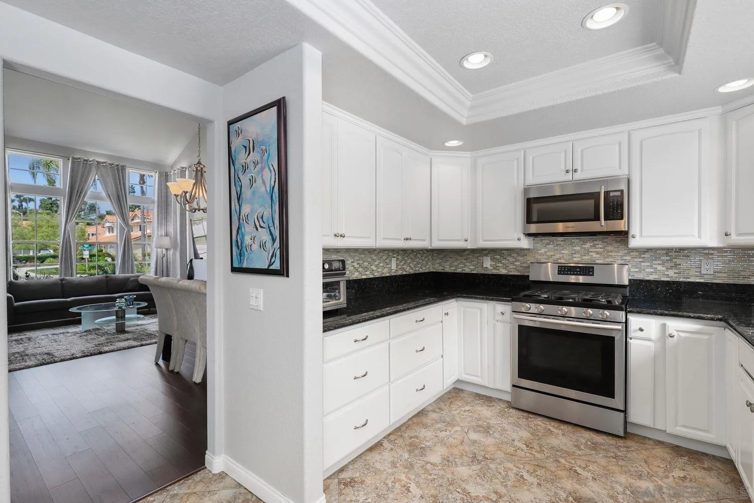 1769 Willowhaven Road Encinitas, CA 92024 - Photo 10 of 36 a kitchen with granite countertop a stove a microwave a sink and cabinets