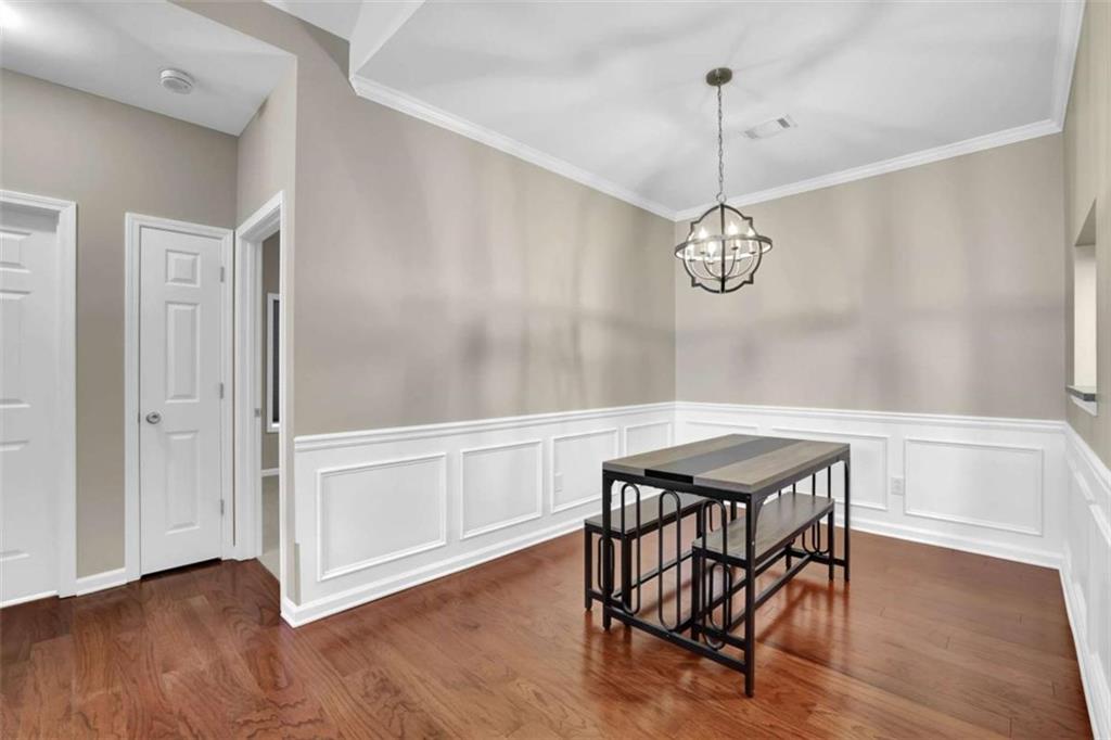 140 Stonegate Lane Canton, GA 30114 - Photo 14 of 38 a view of a dining room with furniture wooden floor and a chandelier