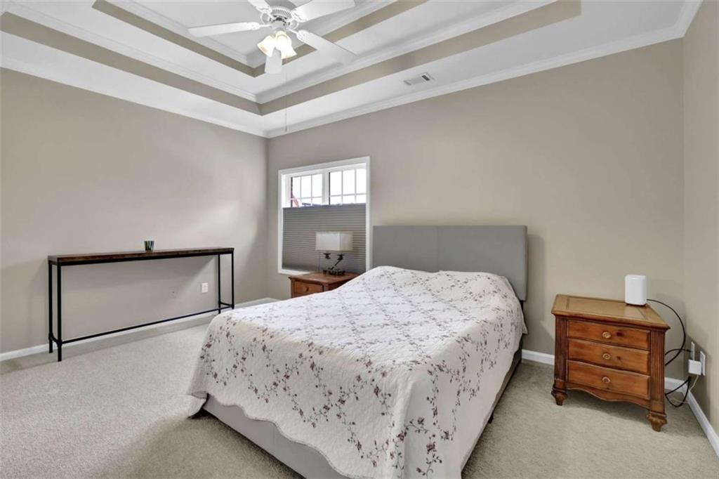 140 Stonegate Lane Canton, GA 30114 - Photo 20 of 38 a bedroom with a bed and a chandelier