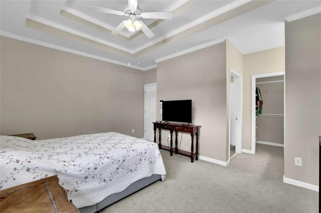 140 Stonegate Lane Canton, GA 30114 - Photo 22 of 38 a bedroom with a bed and a flat screen tv