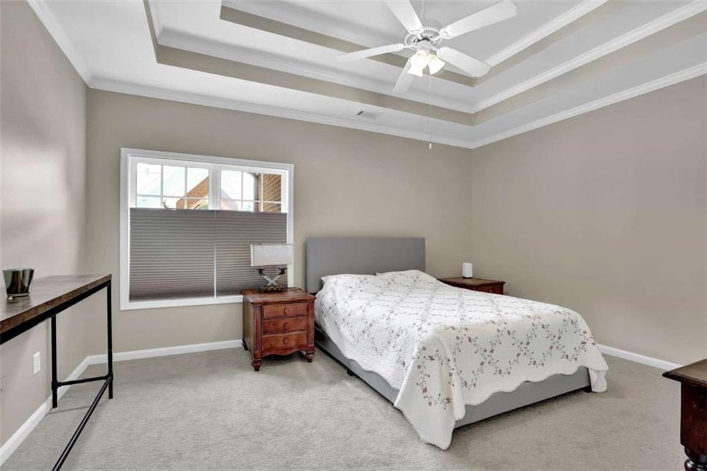 140 Stonegate Lane Canton, GA 30114 - Photo 28 of 38 a bedroom with a bed and a chandelier