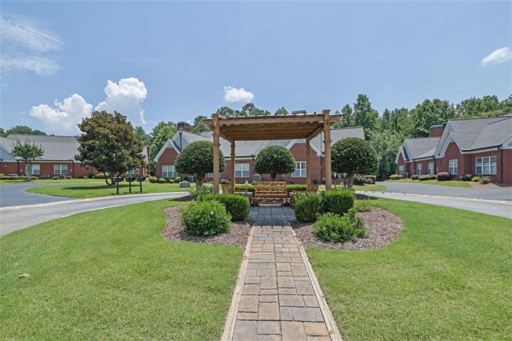 140 Stonegate Lane Canton, GA 30114 - Photo 4 of 38 a front view of a house with a yard and potted plants