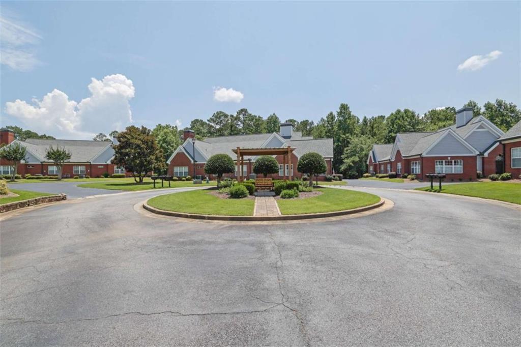 140 Stonegate Lane Canton, GA 30114 - Photo 5 of 38 a view of a white house with a swimming pool and a yard