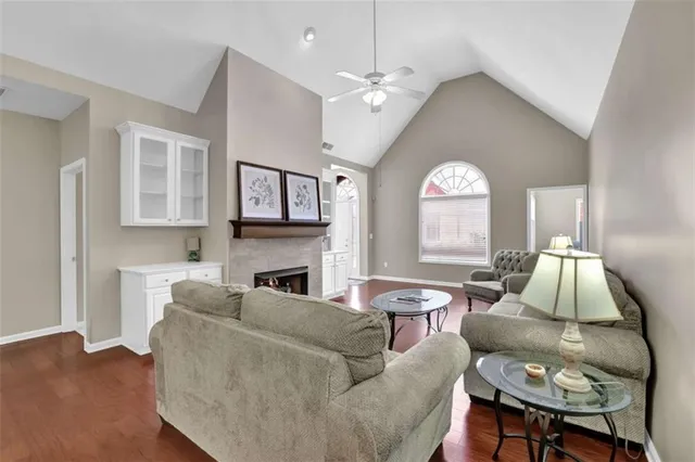 a living room with furniture a fireplace and a large window