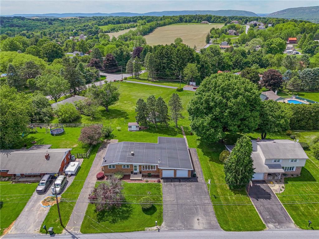 579 Cherry Road Northampton, PA 18067 - Photo 7 of 57 An aerial perspective reveals a vast yard with mature trees and a tranquil, verdant landscape.