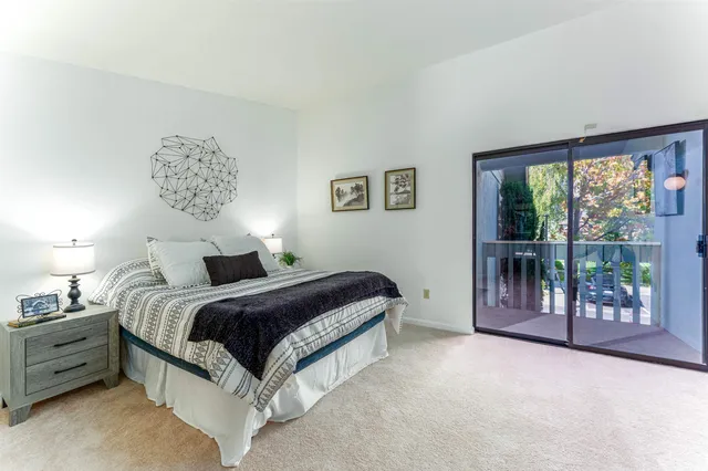 a bedroom with a bed and a lamp with window