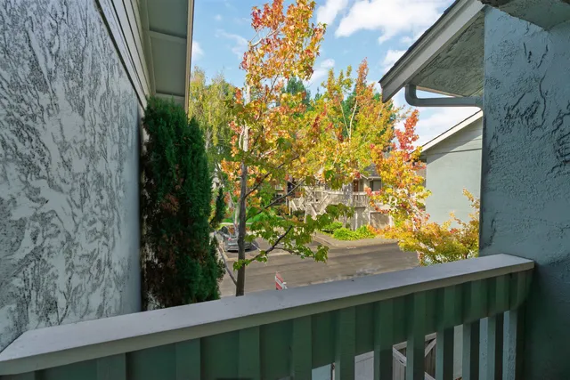 a view of a building with backyard and sitting area