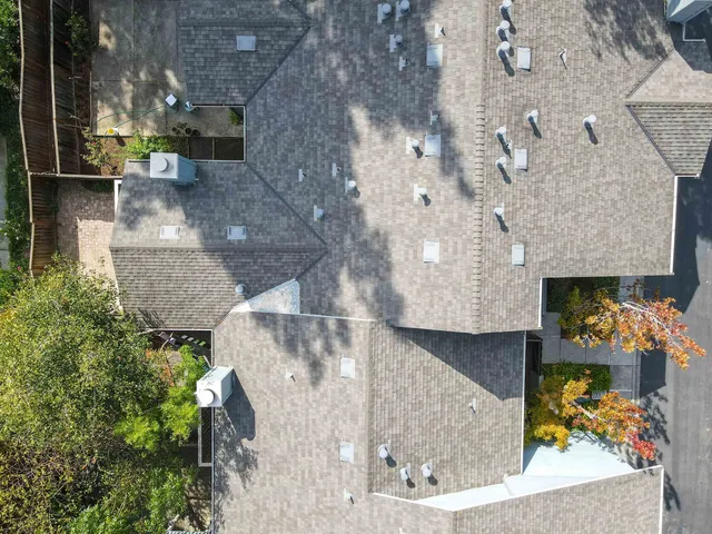 an aerial view of a house with a yard and a fountain