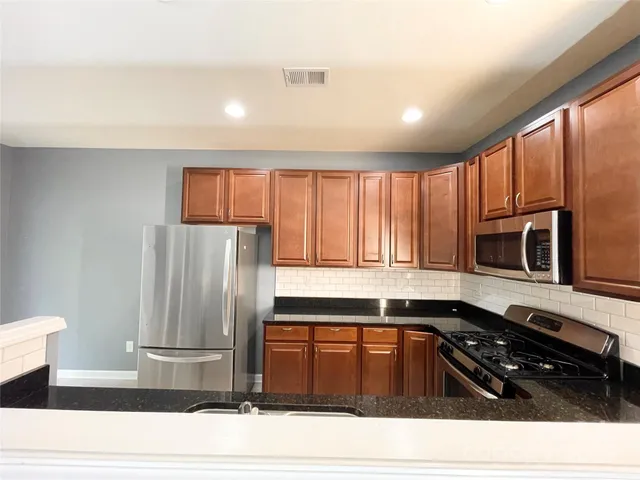 a kitchen with a refrigerator and a sink