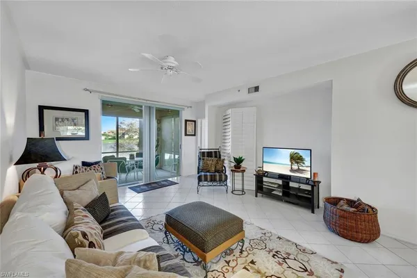 a living room with furniture a table and a window