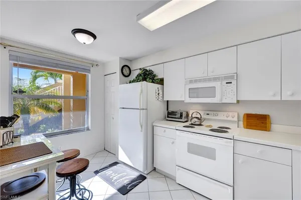 a kitchen with a stove a refrigerator and a sink