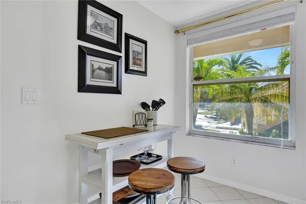 a table with a sink and a painting on the wall