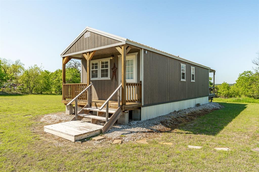 a view of a house with yard and sitting area