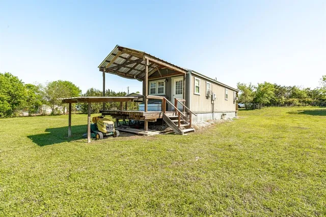 a view of a house with backyard and sitting area