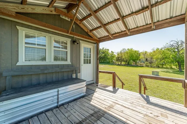a view of a balcony with wooden floor and outdoor seating