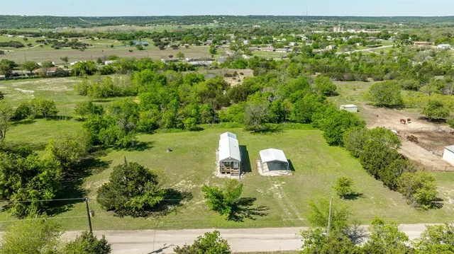 an aerial view of a house with a yard