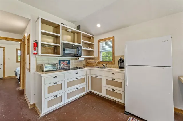 a kitchen with stainless steel appliances a refrigerator sink and cabinets