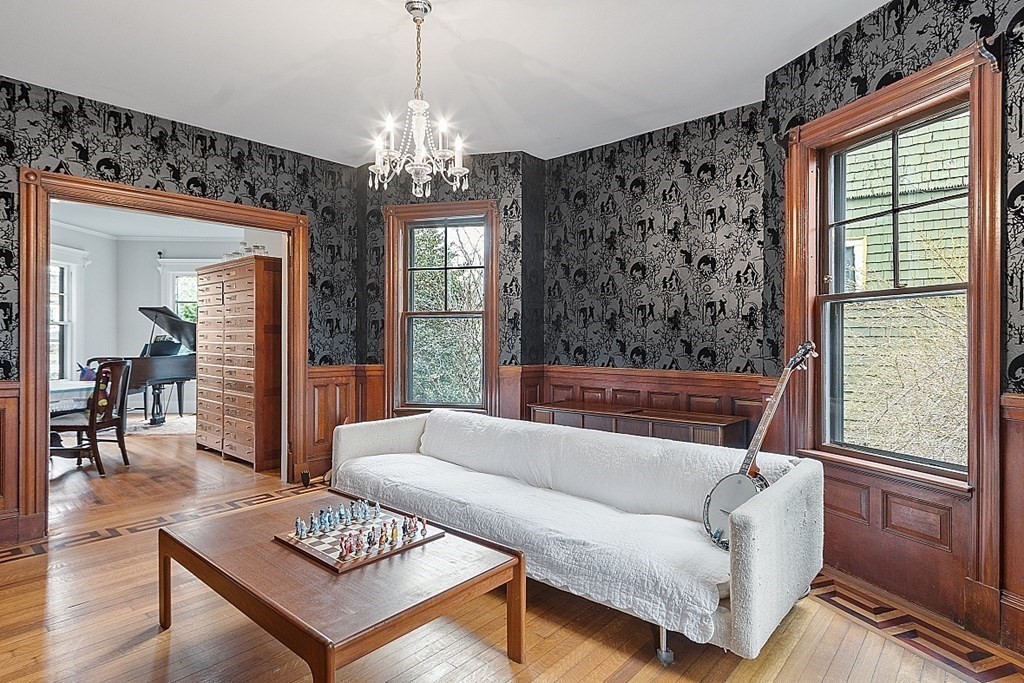 23 Wellesley Park Boston, MA 02124 - Photo 18 of 42 a living room with furniture and a chandelier