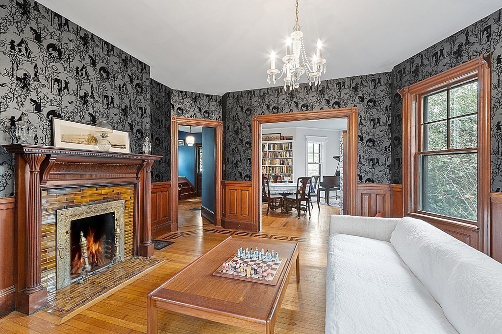 23 Wellesley Park Boston, MA 02124 - Photo 19 of 42 a living room with furniture a fireplace and a chandelier