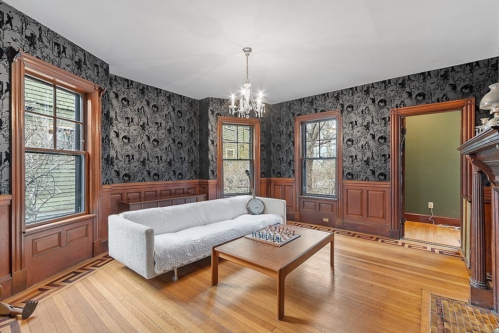 23 Wellesley Park Boston, MA 02124 - Photo 20 of 42 a living room with furniture and a chandelier