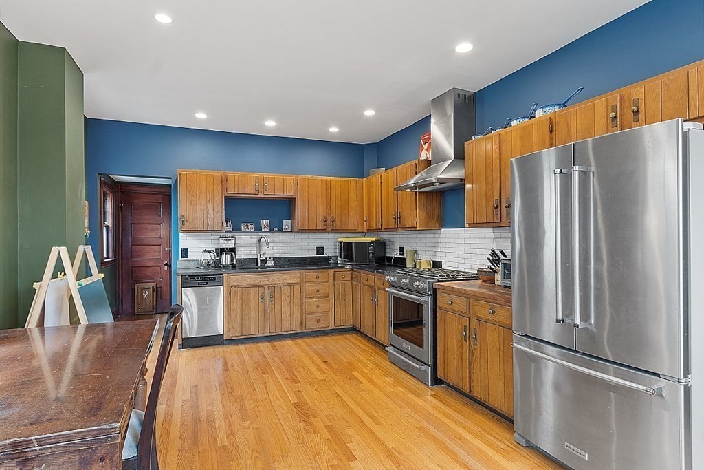 23 Wellesley Park Boston, MA 02124 - Photo 26 of 42 a kitchen with stainless steel appliances granite countertop a refrigerator stove microwave and sink