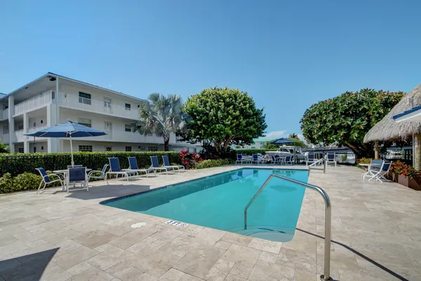 a view of a swimming pool with sitting area