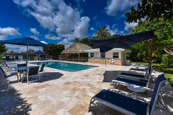 a view of a patio with swimming pool table and chairs