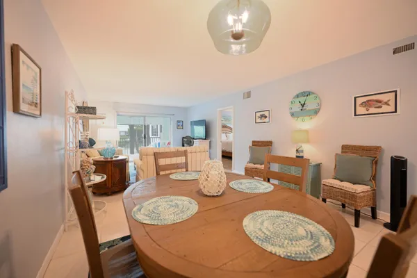 a dining room with furniture a rug and wooden floor