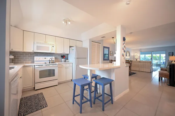 a kitchen with a sink cabinets and window