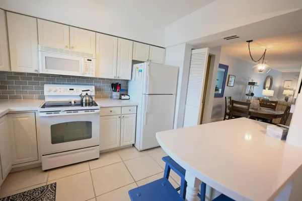 a kitchen with a white cabinets and white appliances