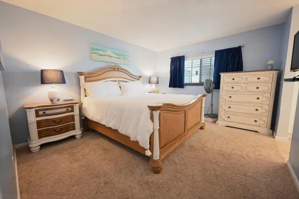 a bedroom with a bed and a night stand