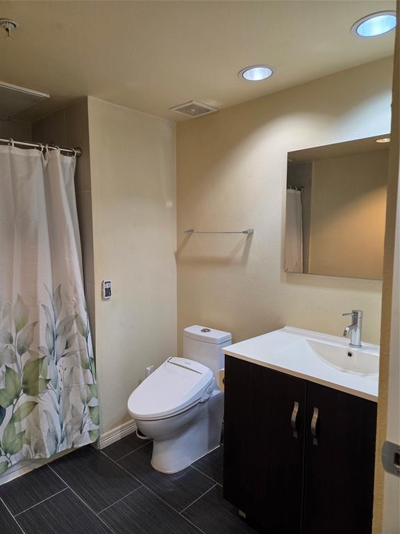 1100 West Trinity Mills Road, Unit 2014 Carrollton, TX 75006 - Photo 12 of 13 a bathroom with a sink toilet and shower