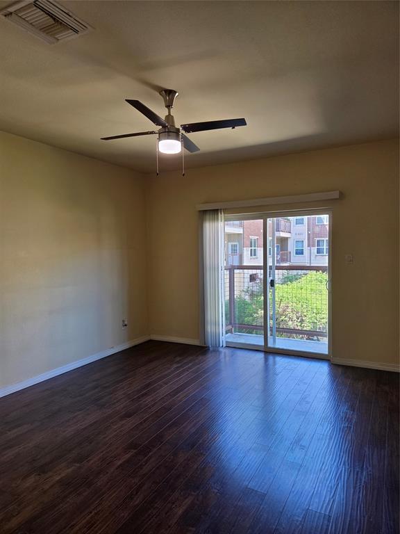 1100 West Trinity Mills Road, Unit 2014 Carrollton, TX 75006 - Photo 3 of 13 a view of an empty room with wooden floor and a window