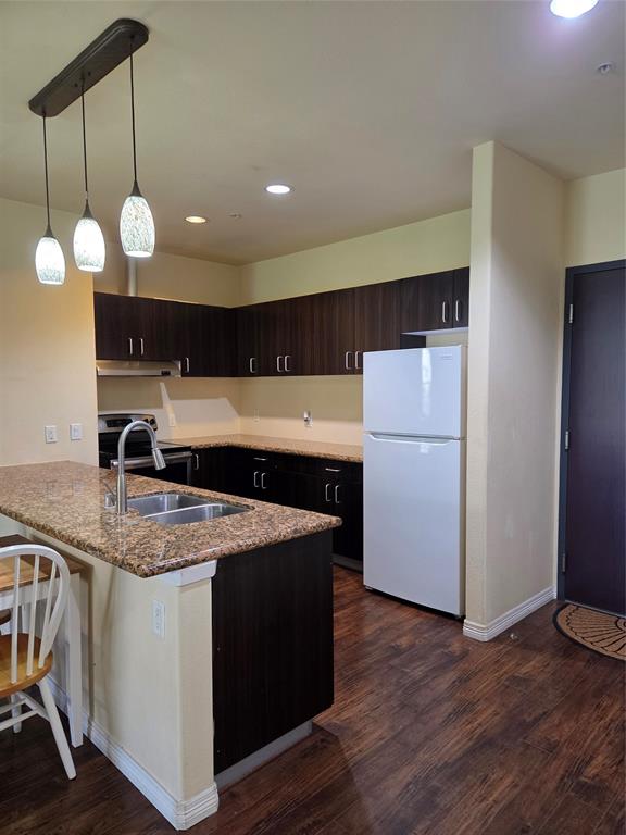 1100 West Trinity Mills Road, Unit 2014 Carrollton, TX 75006 - Photo 4 of 13 a kitchen that has a lot of cabinets and wooden floor